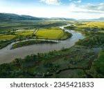 A breathtaking aerial view of Paradise Valley and Yellowstone River under a bright cloudy sky