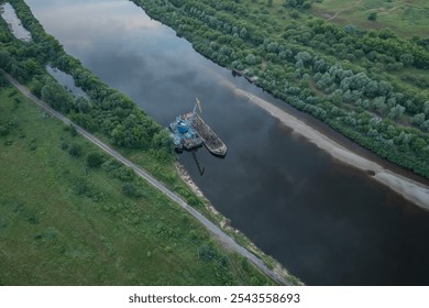 A breathtaking aerial view showcasing a serene riverbank featuring a tugboat amidst lush greenery - Powered by Shutterstock