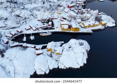 A breathtaking aerial view of a snowcovered coastal village showcasing stunning scenery at winter - Powered by Shutterstock