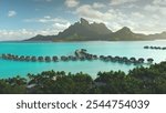 Breathtaking aerial view of turquoise lagoon, palm trees beach, overwater bungalows resort on tropical Bora Bora island. Green mountain sunset light. Popular tourist destination, exotic summer travel