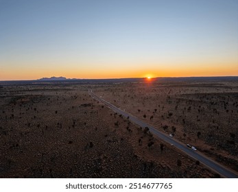 A breathtaking aerial view of Uluru Rock in Australia illuminated by a stunning sunset - Powered by Shutterstock