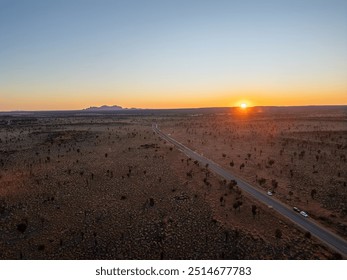 A breathtaking aerial view of Uluru Rock in Australia illuminated by a stunning sunset - Powered by Shutterstock