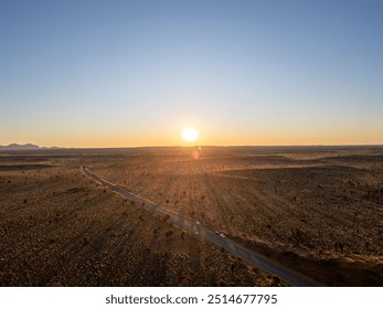 A breathtaking aerial view of Uluru Rock in Australia illuminated by a stunning sunset - Powered by Shutterstock