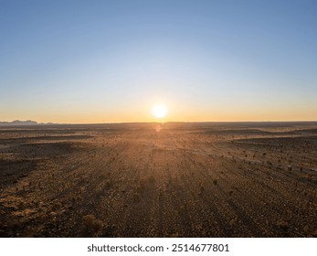 A breathtaking aerial view of Uluru Rock in Australia illuminated by a stunning sunset - Powered by Shutterstock