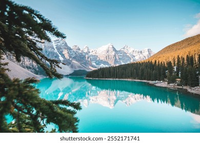 A breathtaking alpine lake with pristine turquoise water reflecting the towering, snow-capped mountains in the background. The evergreen trees lining the shores create a perfect harmony with the seren - Powered by Shutterstock