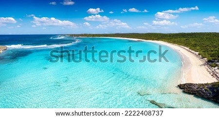 The breathtaking beach at Dean's Blue Hole, Long Island, Bahamas, with turquoise sea next to lush mangrove forest and fine, golden sand