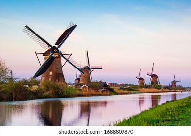 breathtaking beautiful inspirational landscape with windmills in Kinderdijk, Netherlands at sunset. Fascinating places, tourist attraction.