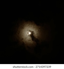 A breathtaking capture of the solar eclipse. The glowing halo of illuminated clouds encircling the Sun marks the moment of totality.