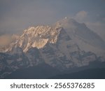 A breathtaking close-up of the Annapurna mountain range, showcasing its towering snow-capped peaks. This majestic Himalayan landscape embodies the raw power and serene beauty of Nepal