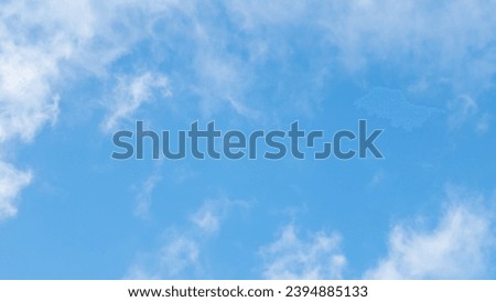 A breathtaking close-up reveals a dynamic sky of white and gray cumulus, cirrus and stratus clouds.