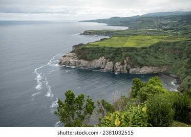 Breathtaking Coastal Landscape of Sao Miguel, Azores with Lush Green Fields and Rugged Cliffs - Powered by Shutterstock