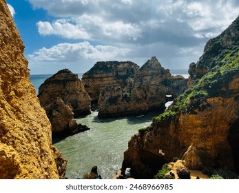 
A breathtaking coastal view featuring rugged cliffs, clear blue sky, and calm sea waters, highlighting nature's raw beauty - Powered by Shutterstock