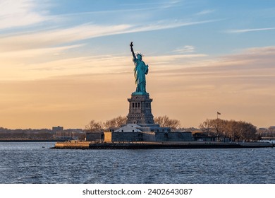 A breathtaking image of the iconic Statue of Liberty in New York City, USA, against a stunning sunset sky - Powered by Shutterstock