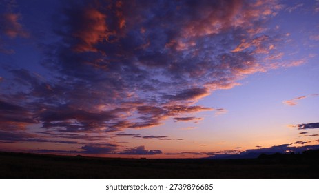 A breathtaking image showcasing a dramatic sunset sky with intense orange and purple hues. The vibrant colors and swirling cloud formations create a mesmerizing scene. Ideal for use in editorial design, backgrounds, and atmospheric imagery. The rich colors and powerful composition create a visually impactful and memorable image.