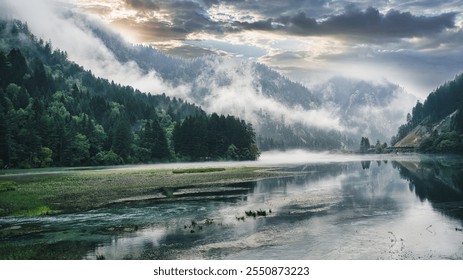 A breathtaking landscape of a river flowing through a misty valley, framed by dense forests and rugged mountains. The dramatic sky, with streaks of sunlight breaking through clouds, enhances the tranq - Powered by Shutterstock