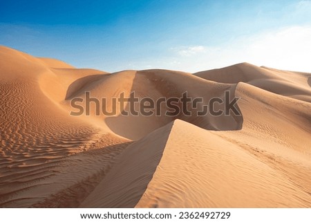 A breathtaking panorama of the Middle Eastern desert dunes set against a vivid azure sky, an irresistible destination for traveler