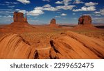 Breathtaking panorama of Monument Valley with striking sandstone formations under a vibrant sky.