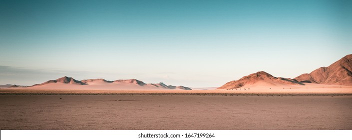 A Breathtaking Panoramic Shot Of Desert Plains In Namibia Africa With Hills In The Background