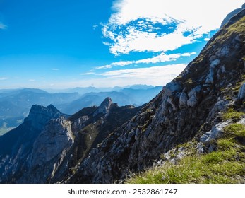 Breathtaking panoramic view of a mountain range of Gesäuse, Ennstal Alps, Styria, Austria. Ridges rise against clear blue sky, their peaks shrouded in mist. Rugged terrain in Austrian Alps. Wanderlust - Powered by Shutterstock