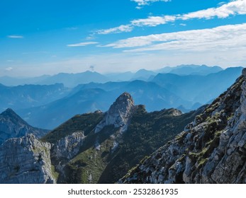 Breathtaking panoramic view of a mountain range of Gesäuse, Ennstal Alps, Styria, Austria. Ridges rise against clear blue sky, their peaks shrouded in mist. Rugged terrain in Austrian Alps. Wanderlust - Powered by Shutterstock