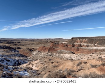 A breathtaking panoramic view of the Painted Desert in Arizona, showcasing its rugged, arid landscape with vibrant red rock formations, clear blue sky, and dramatic terrain, highlighting the beauty. - Powered by Shutterstock