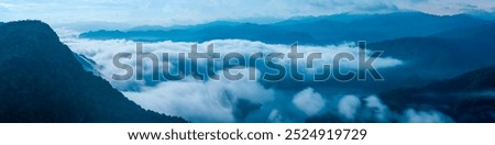 A breathtaking panoramic view of a sea of clouds below a crescent moon and a starry night sky. The silhouette of distant mountains adds depth and drama to this serene landscape. Xindian, Taiwan.
