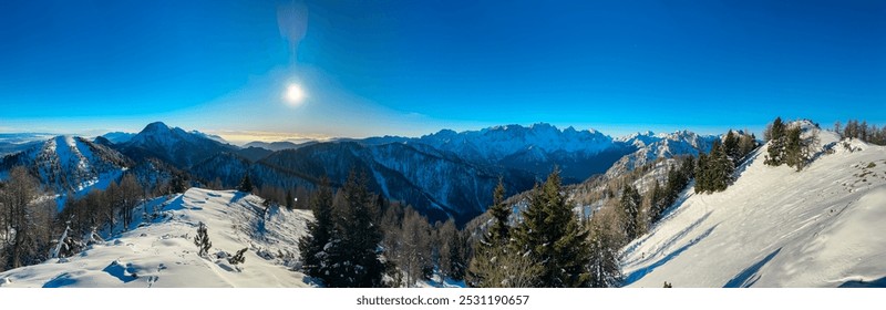 Breathtaking panoramic view of snow-capped mountain range Julian Alps seen from Karawanks in Carinthia, Austria Slovenia border. Majestic rugged jagged peaks on clear blue sky winter day. Ski touring - Powered by Shutterstock