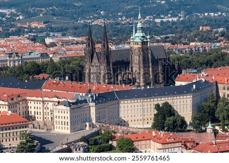 Breathtaking panoramic view of St. Veits Dom and Prague Castle Prazsky hrad seen from Petrin hill in Prague, Czechia. Historic buildings and red-tiled rooftops of city stretch out towards the horizon
