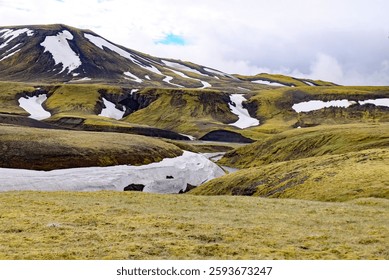 A breathtaking scene of a stream cascading down a snow-covered mountain range