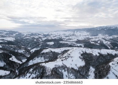 A breathtaking snowy mountain range seen from above Piatra Craiului aerial drone - Powered by Shutterstock