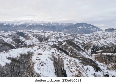 A breathtaking snowy mountain range seen from above Piatra Craiului aerial drone - Powered by Shutterstock