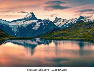 Breathtaking summer sunrise on Bachalpsee lake with Schreckhorn and Wetterhorn peaks on background. Astonishing morning scene in the Swiss Bernese Alps, Switzerland, Europe.  - Powered by Shutterstock