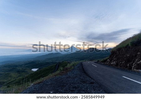 Similar – Image, Stock Photo Misty sunrise over winding road in La Mancha, Spain