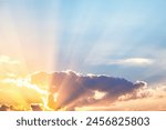 Breathtaking sunrise with radiant sunbeams piercing through clouds, ideal for vibrant and hopeful themes in all creative projects