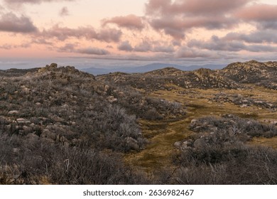A breathtaking sunset cloudscape over hillside rocks in Mount Buffalo National Park, Australia