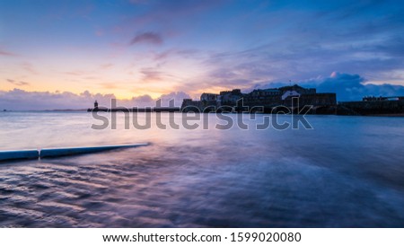 A breathtaking sunset over the historic Castle Cornet at the seashore in Guernsey