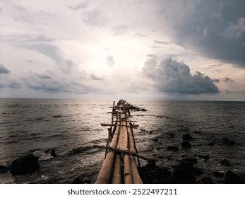 Breathtaking sunset over tranquil ocean with rustic wooden pier. Perfect for travel, adventure, or meditation themes. Dramatic clouds reflect on calm waters. Ideal background for inspirational quotes. - Powered by Shutterstock