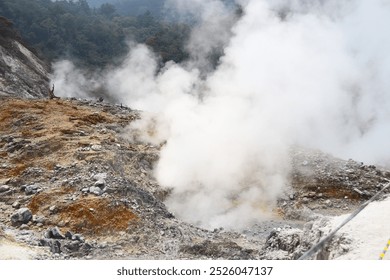 A breathtaking view of an active volcanic crater emitting thick white steam, signaling geothermal activity. The rugged terrain and rising vapors capture nature's raw power - Powered by Shutterstock