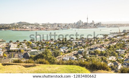 Breathtaking view of Auckland city skyline and bay gulf from Mount Victoria in Devonport area - High angle sight of the New Zealand world famous town - Bright greenish vintage filter