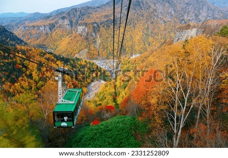 A breathtaking view from a cable car overlooking colorful autumn forests on the mountainside in Sounkyo Gorge (層雲峡) in Daisetsuzan (大雪山) National Park, in Kamikawa, Hokkaido Japan