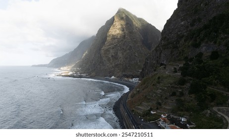 A breathtaking view of a coastal road winding along towering cliffs, with gentle ocean waves and dramatic cloud formations overhead, creating a sense of adventure and tranquility. - Powered by Shutterstock