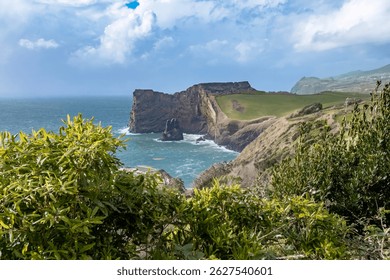 Breathtaking view of the dramatic cliffs and turquoise waters of Sao Jorge, Azores. South coast of Sao Jorge (Azores islands) near Velas with volcanic rock Morro de Lemos.