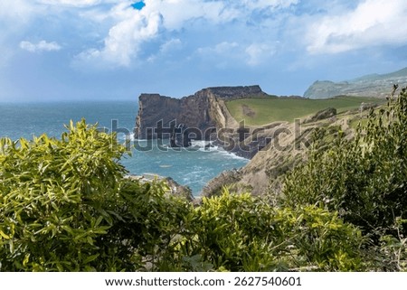 Breathtaking view of the dramatic cliffs and turquoise waters of Sao Jorge, Azores. South coast of Sao Jorge (Azores islands) near Velas with volcanic rock Morro de Lemos.