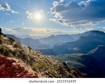 A breathtaking view of the Grand Canyon at sunset, with the sun casting long shadows over the vast canyons and rocky cliffs. The rugged terrain and clear sky create a dramatic and serene landscape. - Powered by Shutterstock