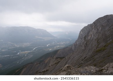 Breathtaking View from Ha Ling Trail Overlooking Misty Mountain Peaks on a Rainy Day in Banff, Alberta, Canada – Moody and Atmospheric Landscape Photography - Powered by Shutterstock