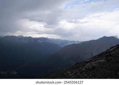 Breathtaking View from Ha Ling Trail Overlooking Misty Mountain Peaks on a Rainy Day in Banff, Alberta, Canada – Moody and Atmospheric Landscape Photography - Powered by Shutterstock