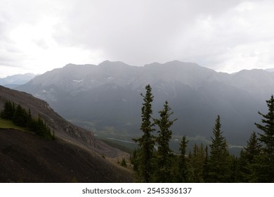 Breathtaking View from Ha Ling Trail Overlooking Misty Mountain Peaks on a Rainy Day in Banff, Alberta, Canada – Moody and Atmospheric Landscape Photography - Powered by Shutterstock