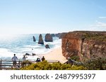 A breathtaking view of the iconic limestone stacks known as the Twelve Apostles, rising majestically from the turquoise waters along the Great Ocean Road in Victoria, Australia.