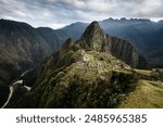 A breathtaking view of Machu Picchu, the ancient Incan city perched high in the Andes mountains, showcasing its intricate stone structures against a backdrop of lush green peaks.