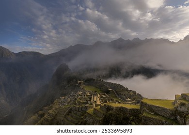 A breathtaking view of Machu Picchu, the ancient Incan city, surrounded by misty mountains and a dramatic sky. - Powered by Shutterstock